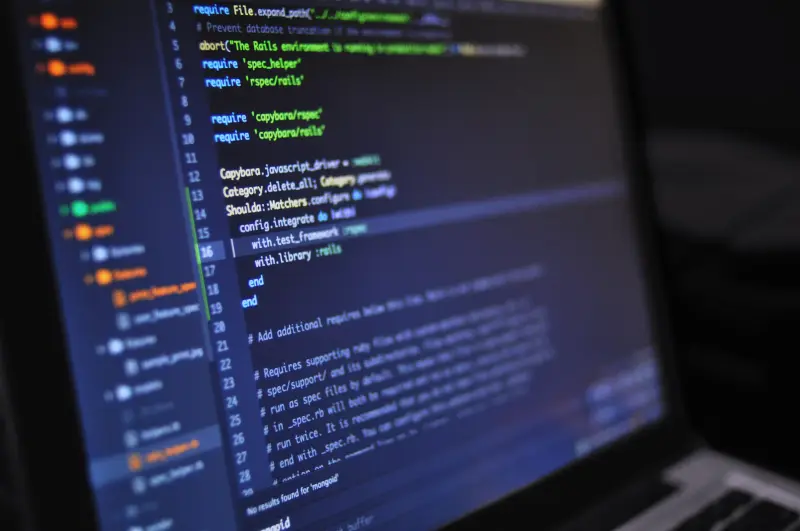 Computer screen displaying colorful programming code in dark theme editor